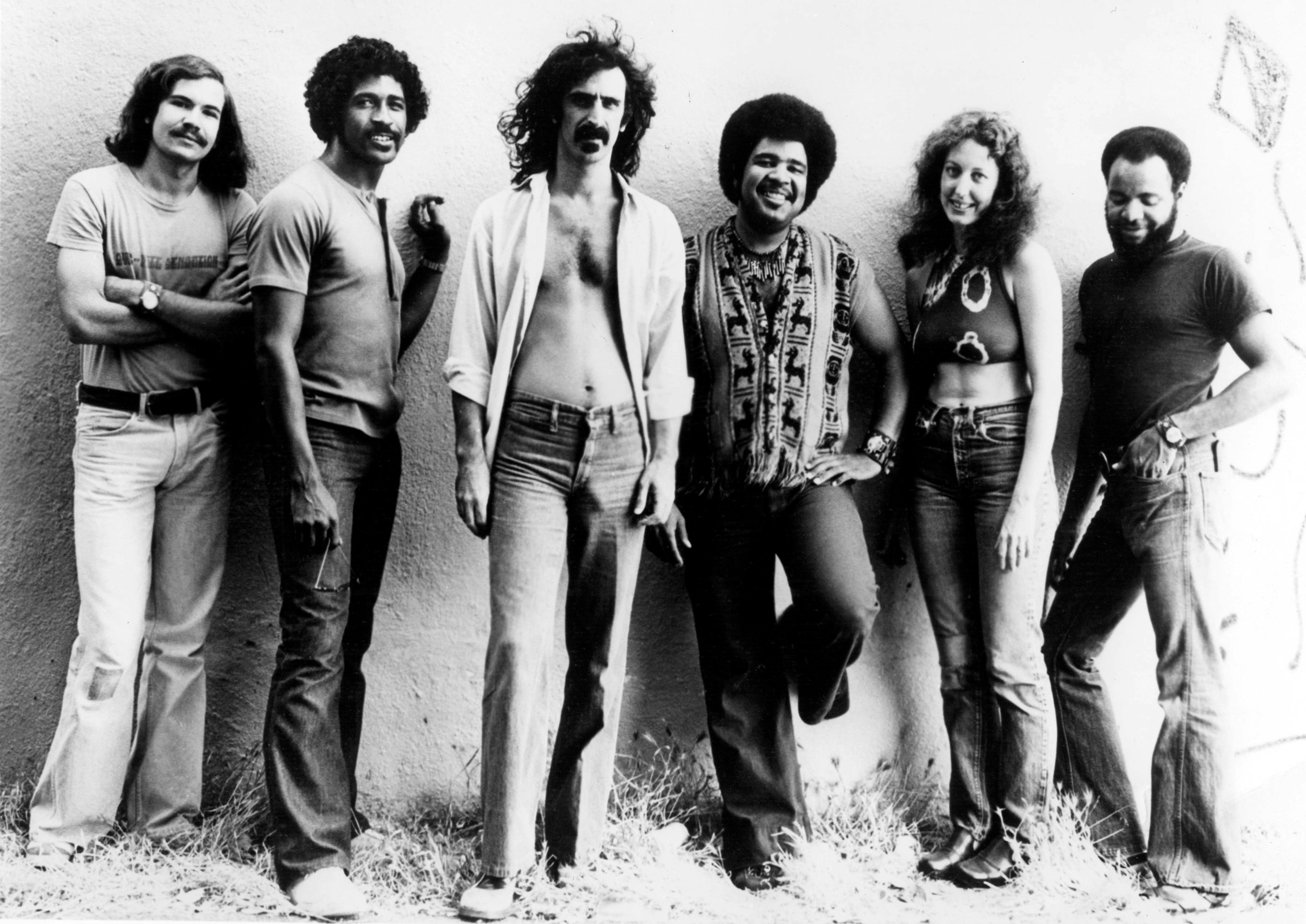 Frank Zappa and the Mothers of Invention, circa 1974. (left to right) Bassist Tom Fowler, saxophonist Napoleon Murphy Brock, singer and guitarist Frank Zappa, keyboard player George Duke, marimba player Ruth Underwood, and drummer Chester Thompson. Photo via RB/Redferns/Getty.